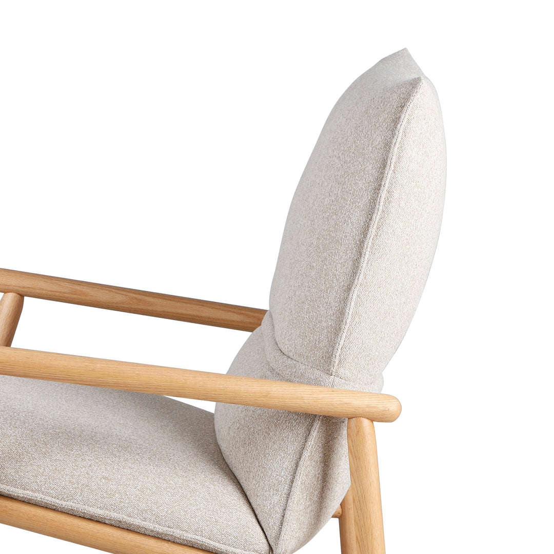 Scandinavian oak wood fabric rocking chair may in still life.