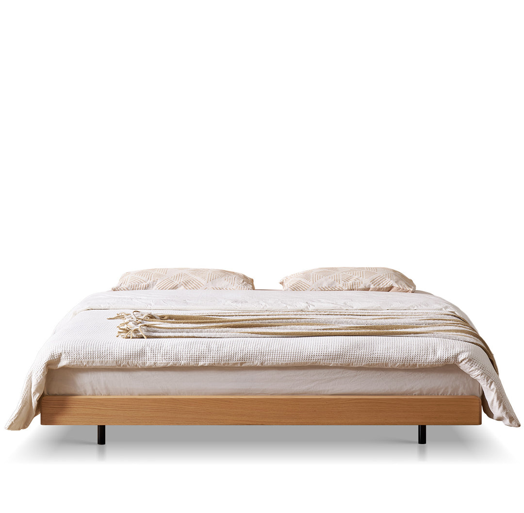 Scandinavian oak wood platform bed nora in white background.