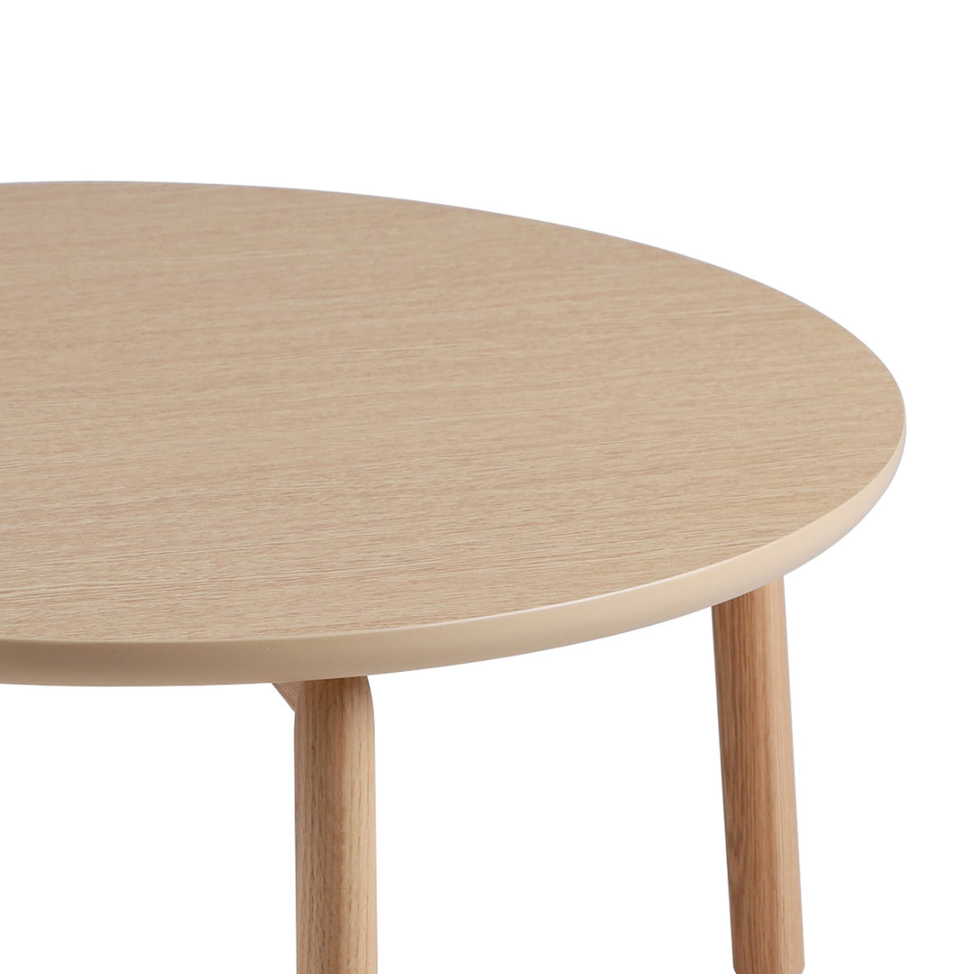 Scandinavian oak wood round coffee table may with context.