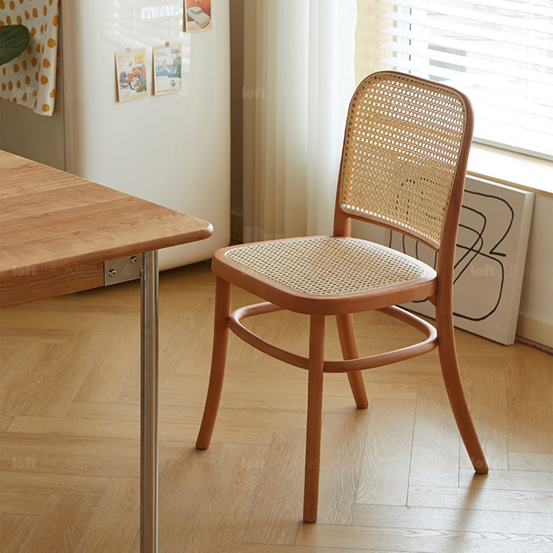 Scandinavian rattan cherry wood dining chair george in still life.