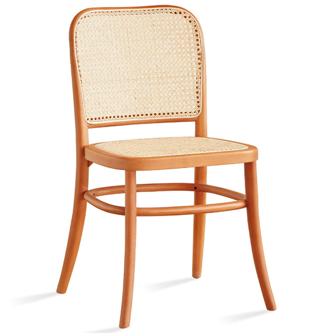 Scandinavian rattan cherry wood dining chair george in white background.