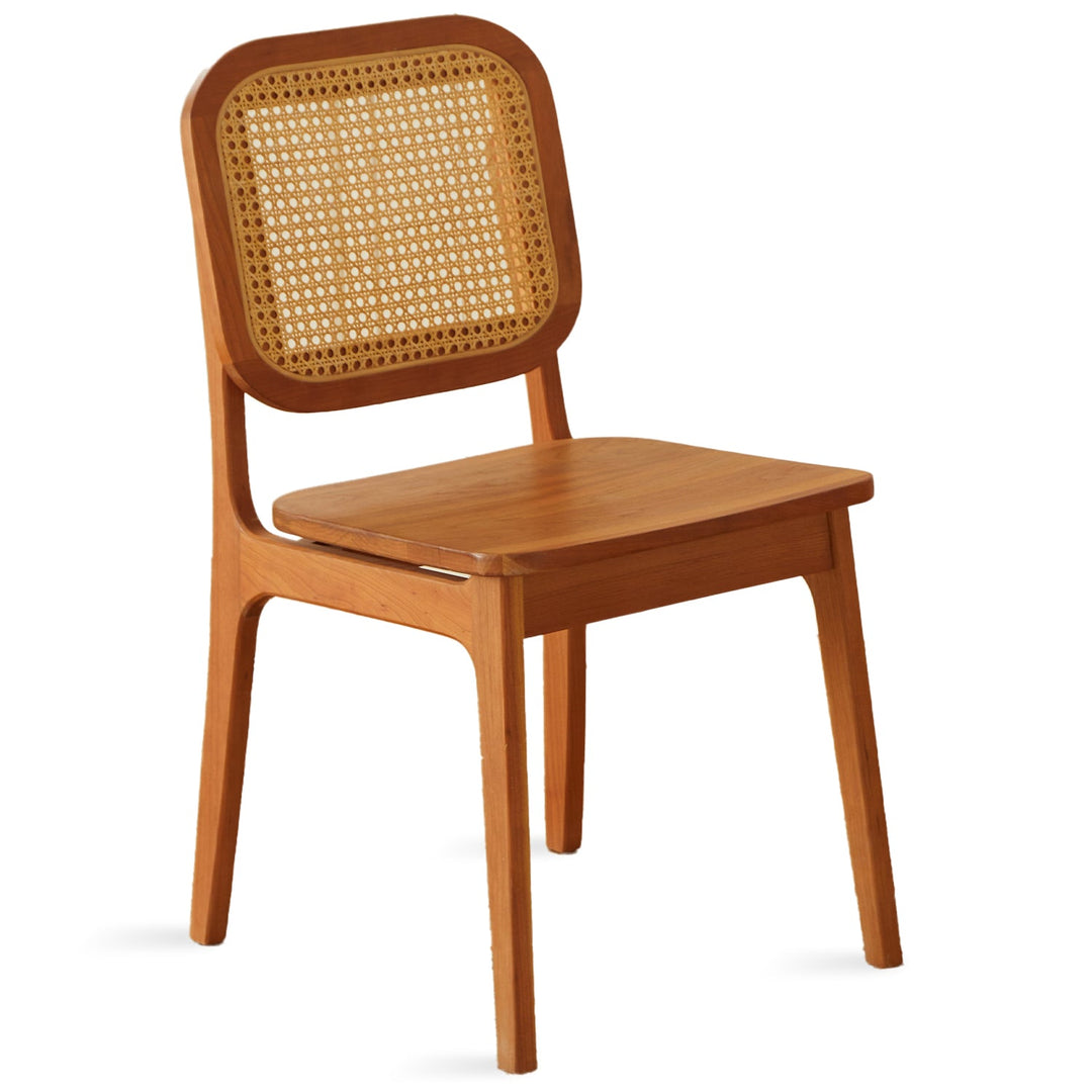 Scandinavian rattan cherry wood dining chair sor in white background.