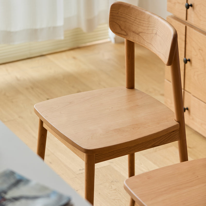 Scandinavian cherry wood dining chair green in panoramic view.