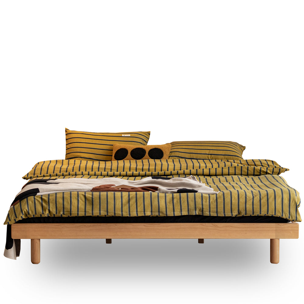 Scandinavian cherry wood platform bed isle in white background.