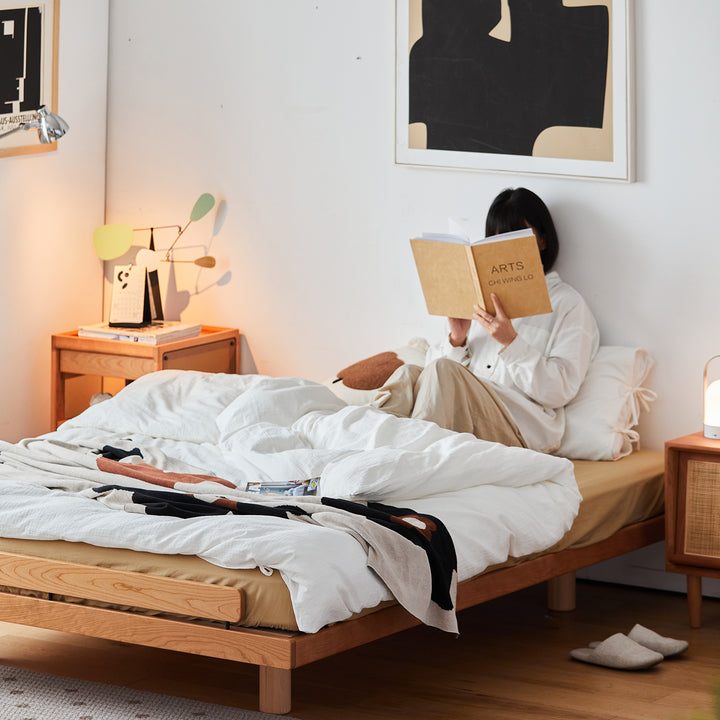 Scandinavian cherry wood platform bed small in real life style.