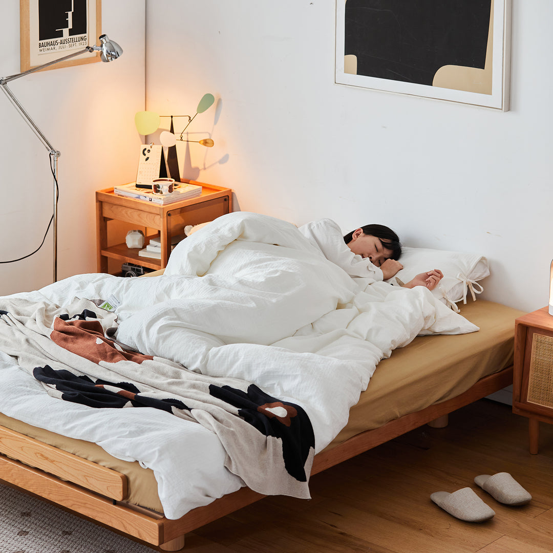 Scandinavian cherry wood platform bed small in close up details.