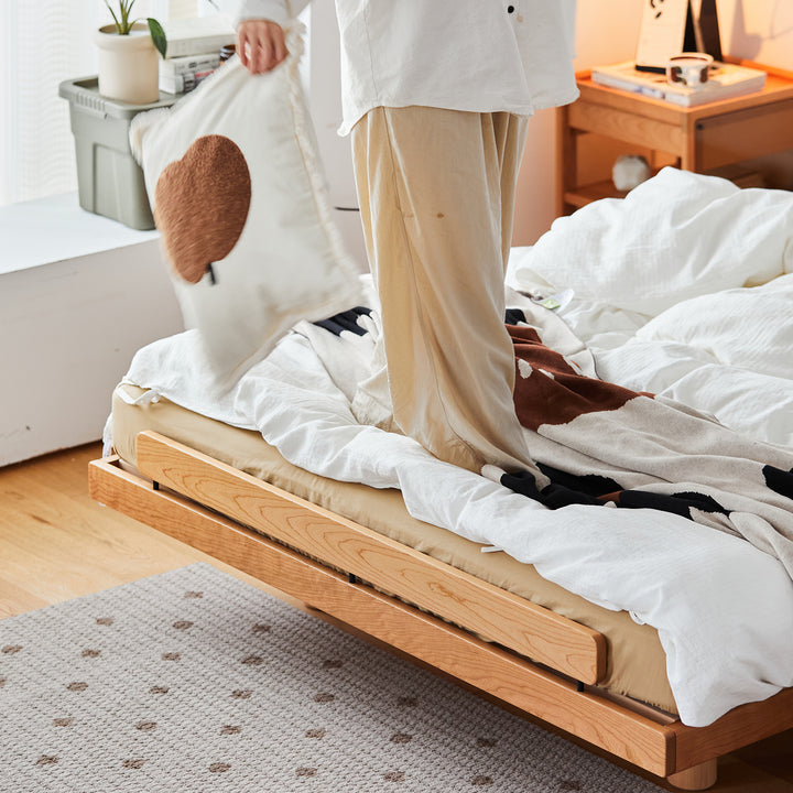 Scandinavian cherry wood platform bed small in panoramic view.