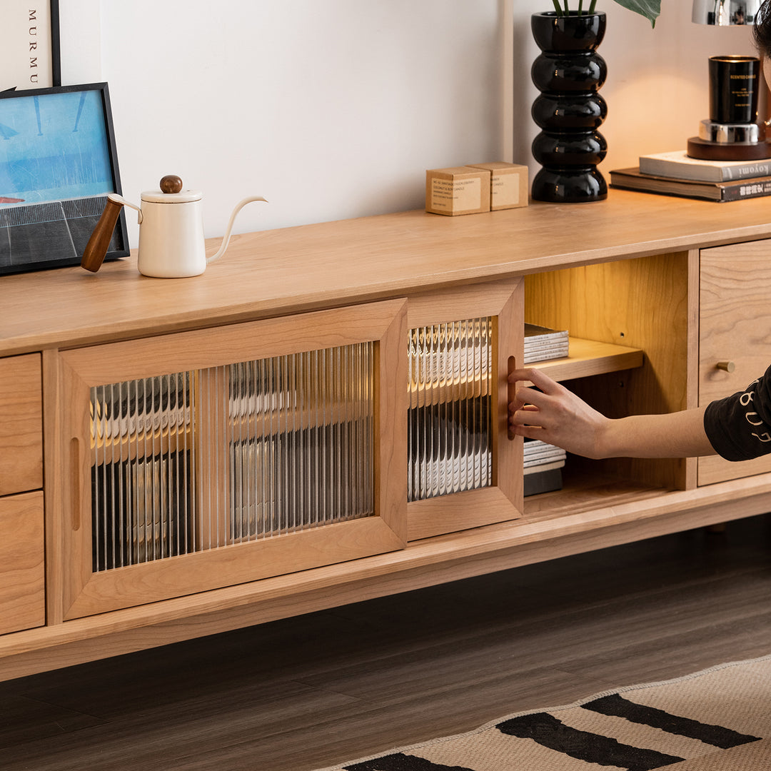 Scandinavian cherry wood tv console green with context.