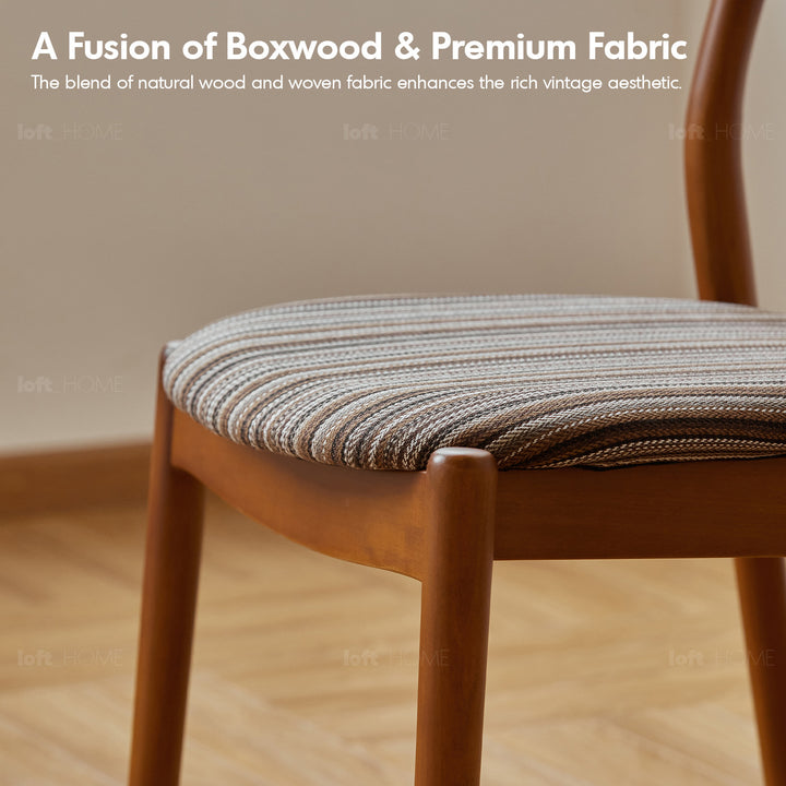Vintage boxwood mix weave fabric cushion stackable dining chair truffle in panoramic view.