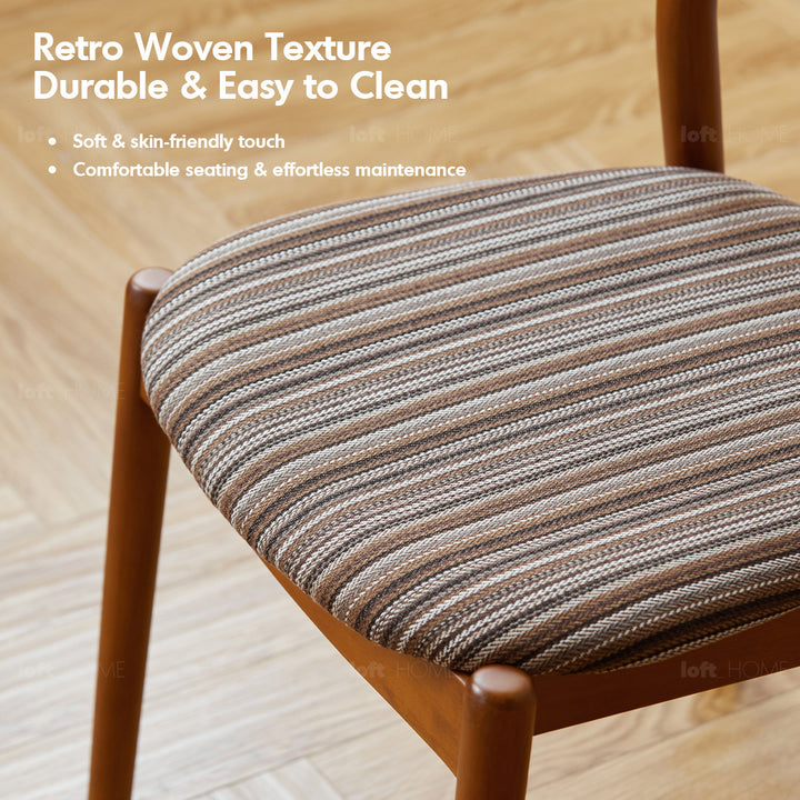 Vintage boxwood mix weave fabric cushion stackable dining chair truffle in still life.