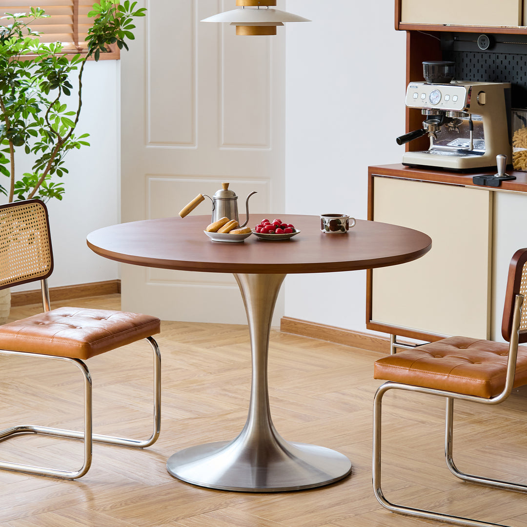 Vintage boxwood stainless steel round dining table tulip in white background.