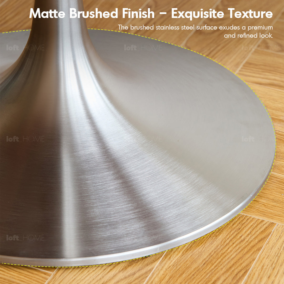 Vintage boxwood stainless steel round dining table tulip in panoramic view.