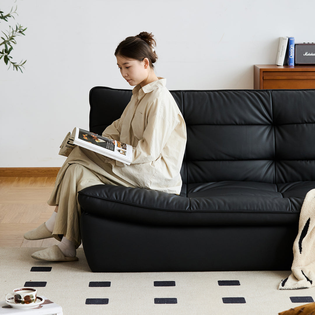 Vintage microfiber leather 3 seater sofa bed lie flat in panoramic view.
