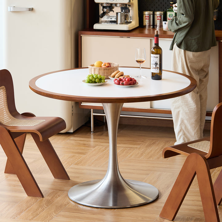 Vintage sintered stone stainless steel round dining table tulip in white background.