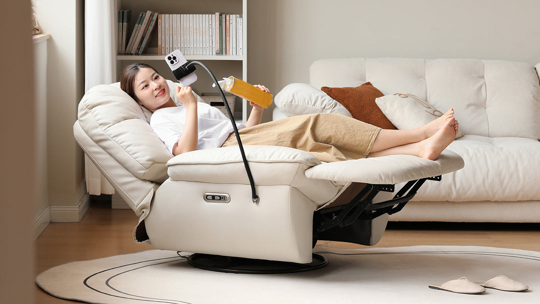 Woman relaxing on a plush recliner chair, enjoying a drink and video streaming, perfect for modern living rooms and cozy lounging.