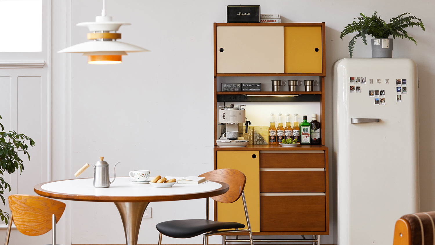 Modern kitchen with a dining table, chairs, and a refrigerator. Loft Home furniture collections. 