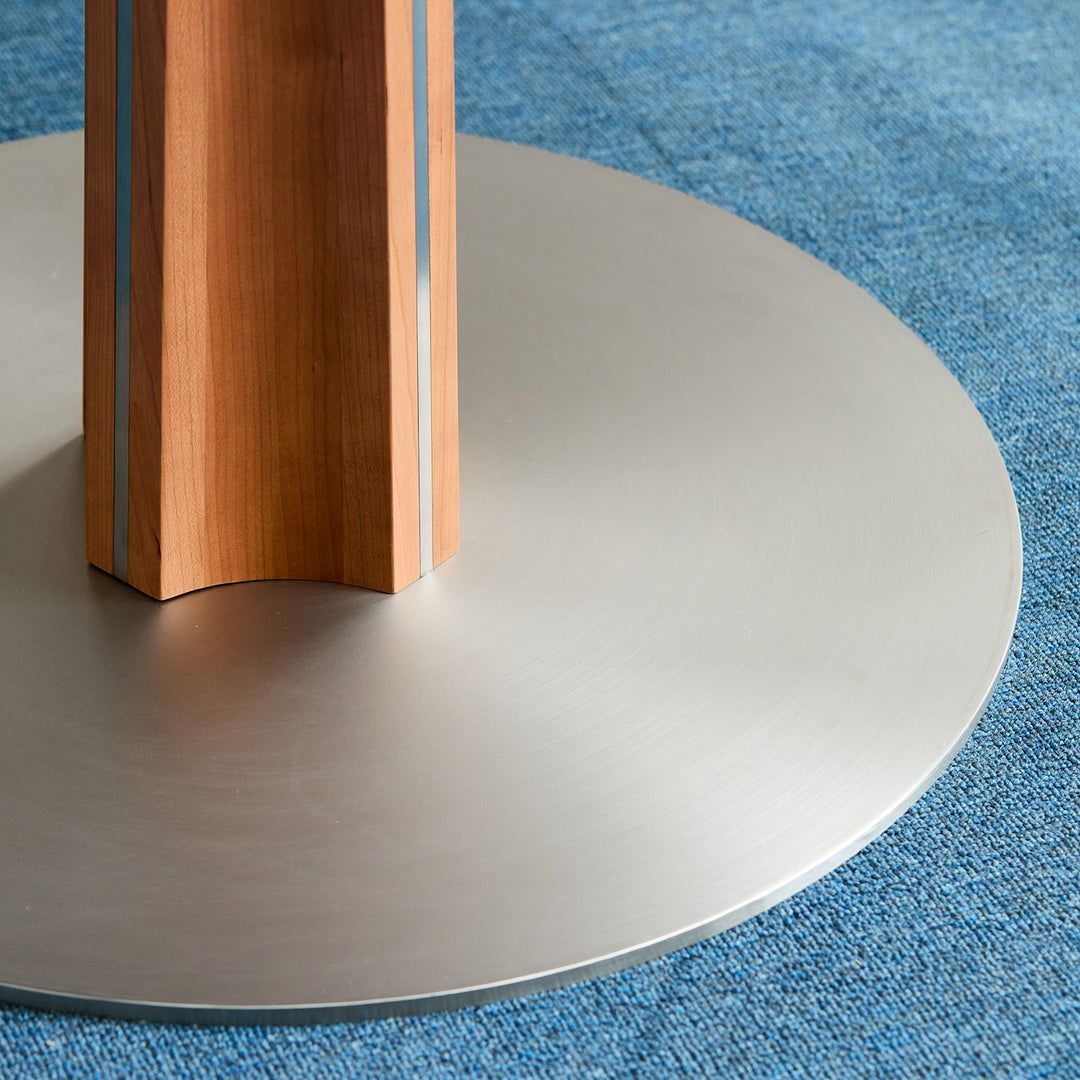 Bauhaus cherry wood sintered stone round dining table pinecone in panoramic view.