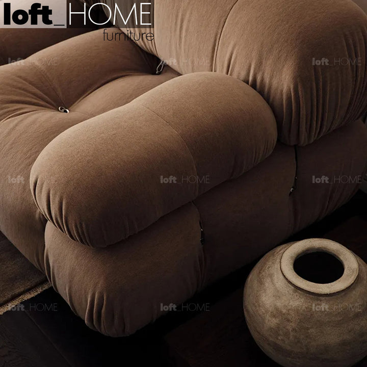Contemporary fabric 1 seater sofa with armrest camaleonda in still life.