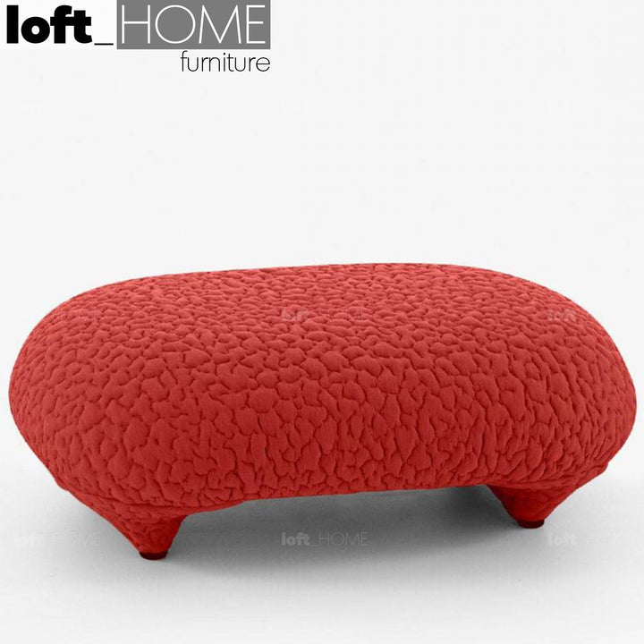 Contemporary fabric ottoman conch moby in still life.