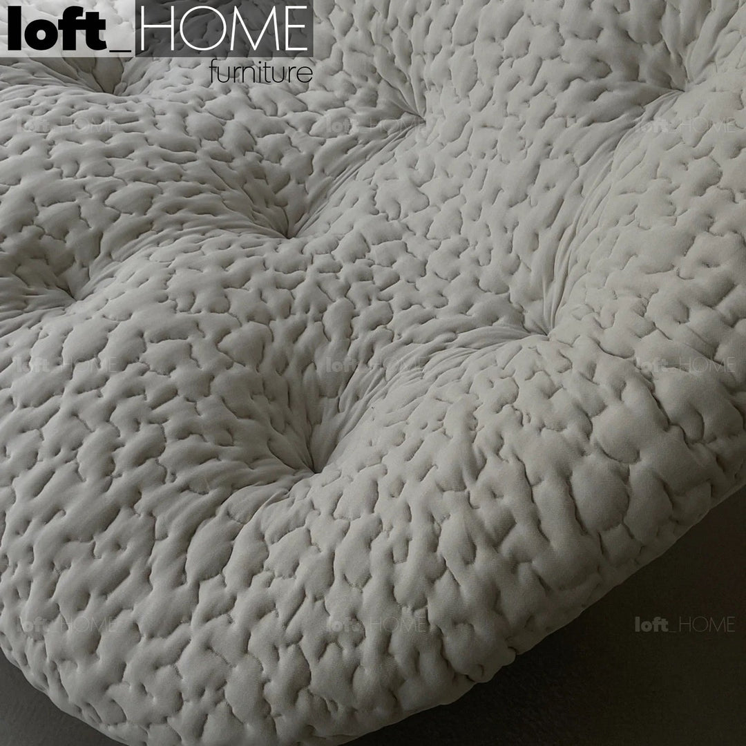 Contemporary fabric ottoman conch moby layered structure.