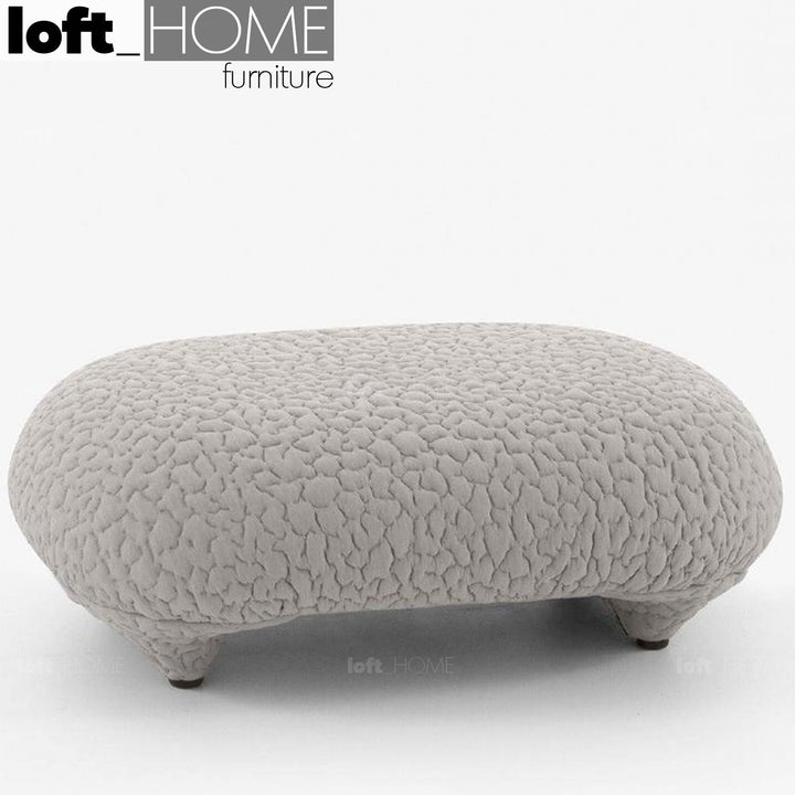Contemporary fabric ottoman conch moby in close up details.
