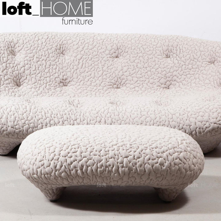 Contemporary fabric ottoman conch moby in real life style.