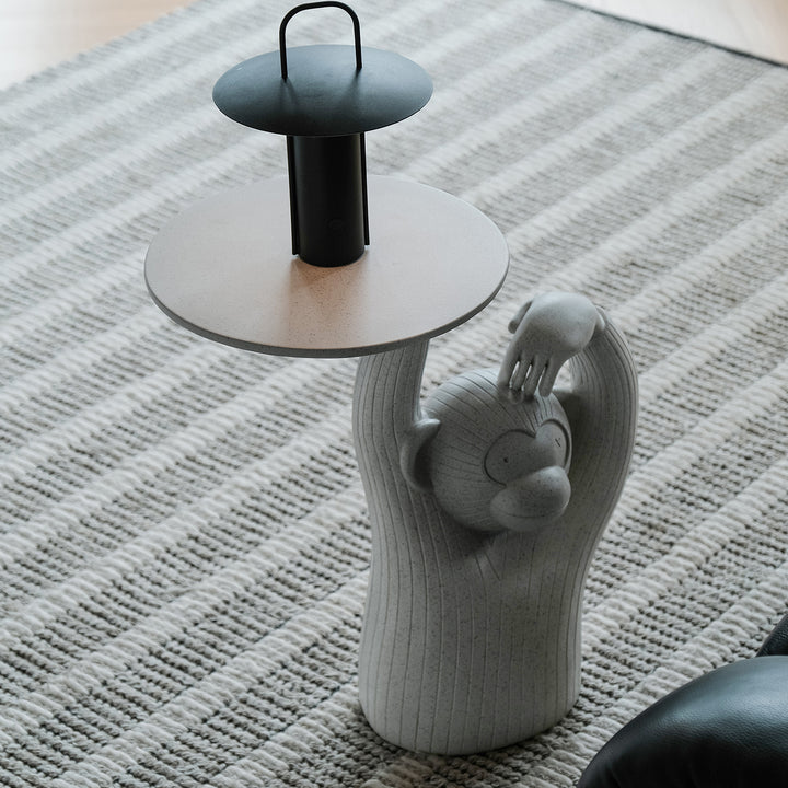 Contemporary fiberglass side table monkey with context.