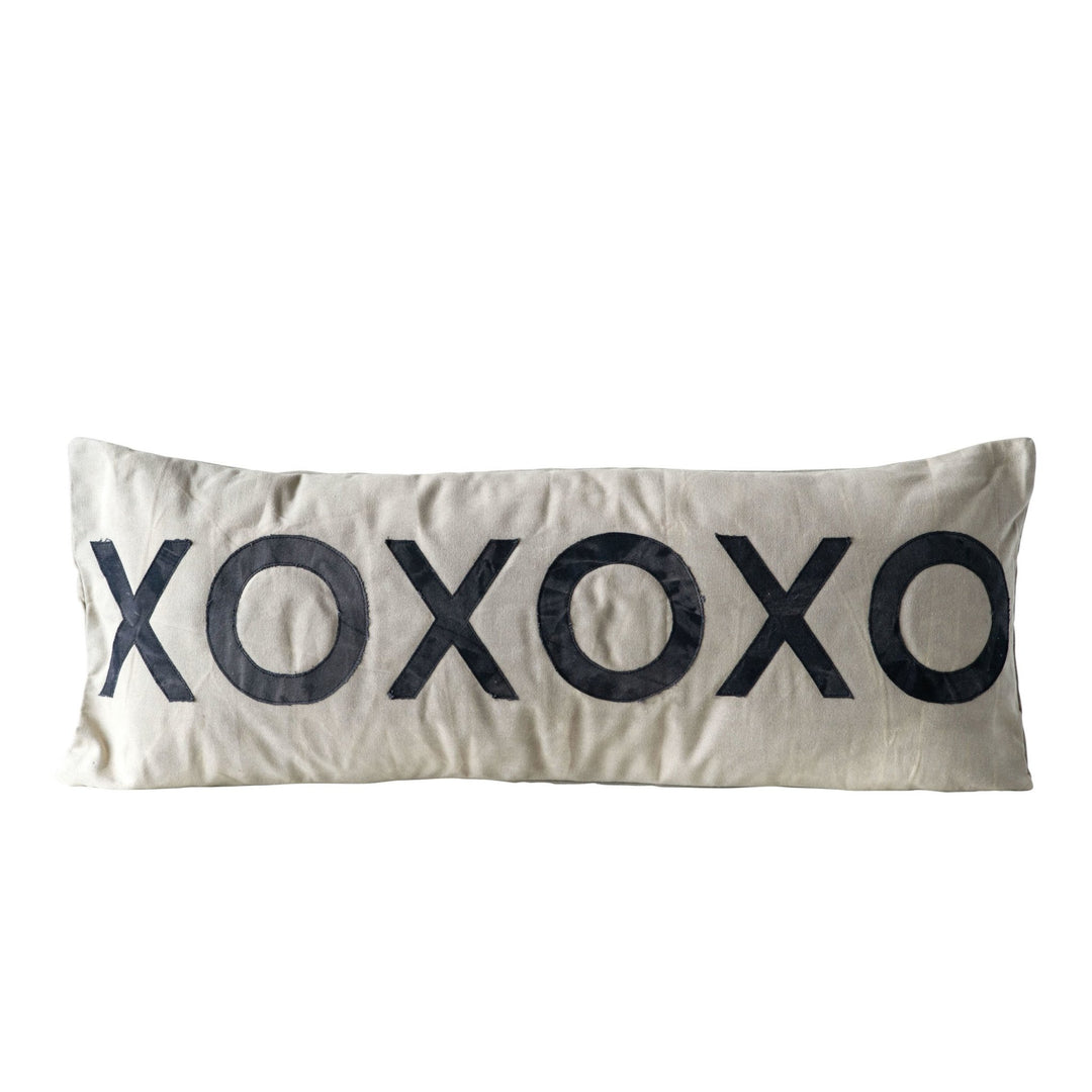 Cotton "xoxoxo" pillow in white background.