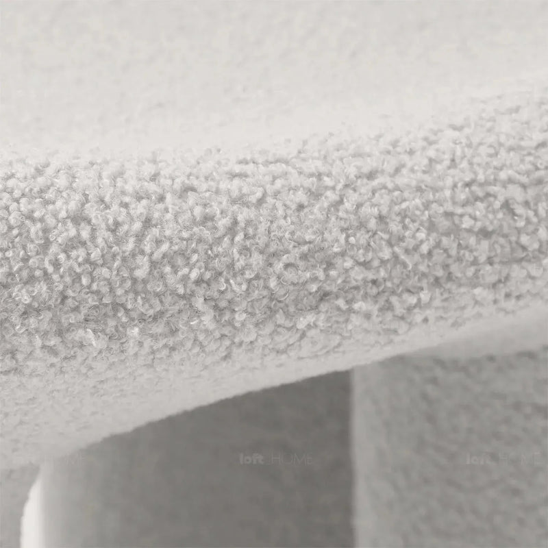 Cream boucle 1 seater sofa mibster in details.