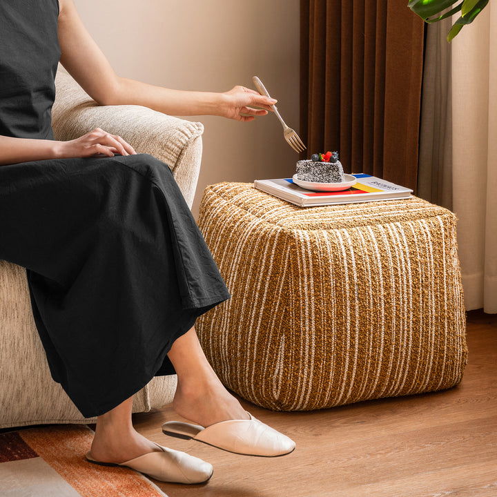 Cream boucle fabric ottoman carry in real life style.