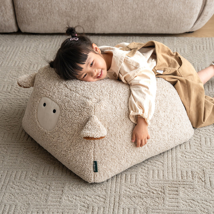 Cream boucle fabric ottoman sheep primary product view.