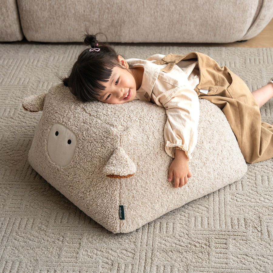 Cream boucle fabric ottoman sheep primary product view.