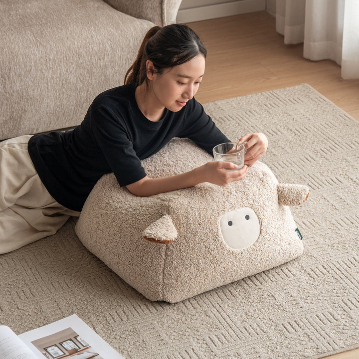 Cream boucle fabric ottoman sheep size charts.