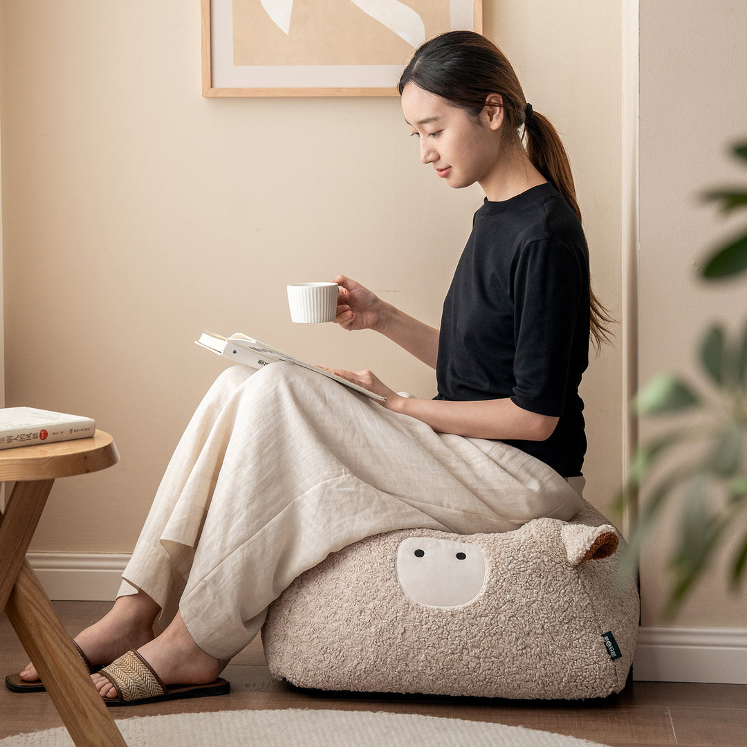 Cream boucle fabric ottoman sheep in real life style.