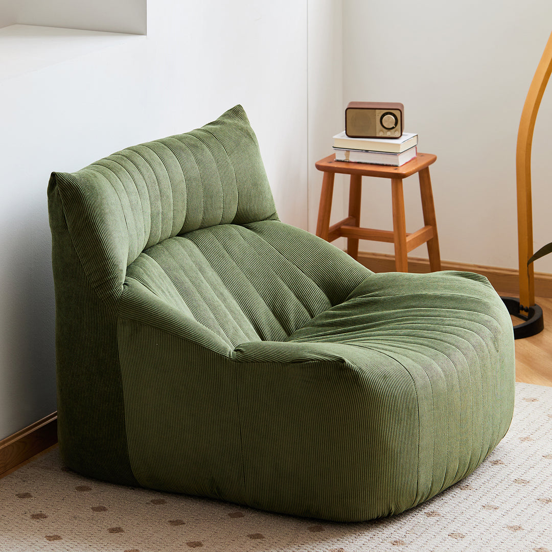 Cream corduroy velvet fabric 1 seater sofa kait with context.