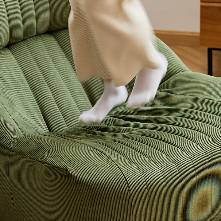 Cream corduroy velvet fabric 1 seater sofa kait in panoramic view.
