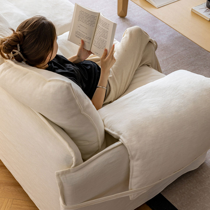 Cream cotton fabric 1 seater sofa folding ear in close up details.