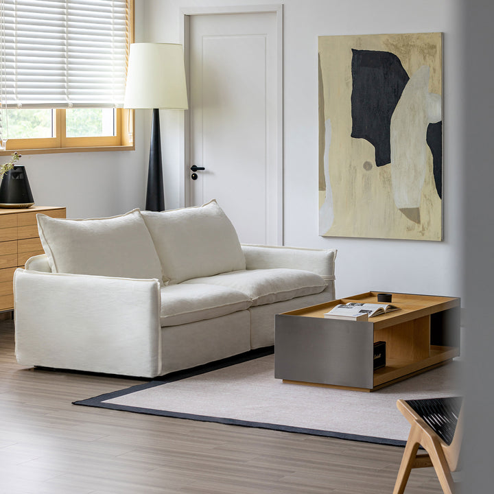 Cream cotton fabric 2 seater sofa folding ear in details.