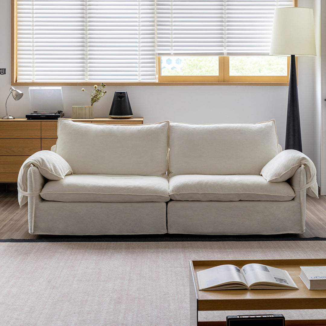 Cream cotton fabric 2 seater sofa folding ear in close up details.