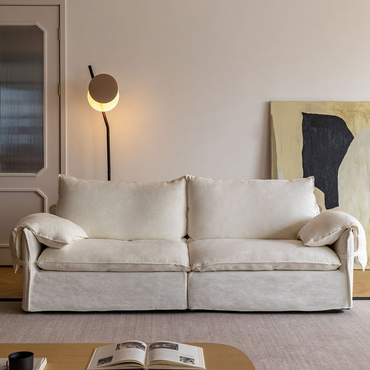 Cream cotton fabric 2 seater sofa folding ear in panoramic view.