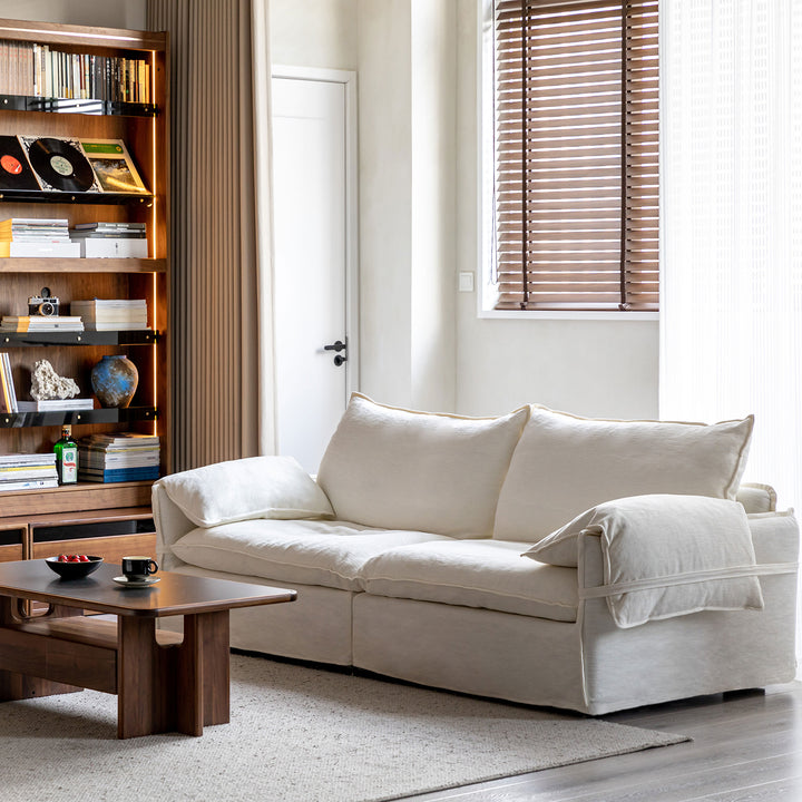 Cream cotton fabric 2 seater sofa folding ear in still life.