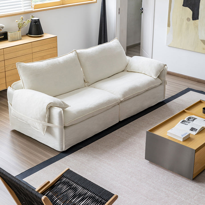 Cream cotton fabric 3 seater sofa folding ear in details.