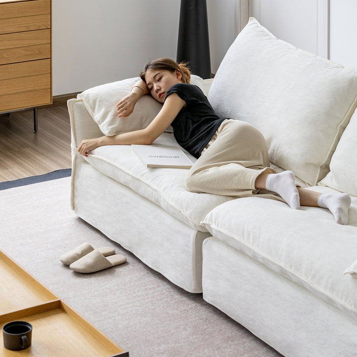 Cream cotton fabric 4 seater sofa folding ear in details.