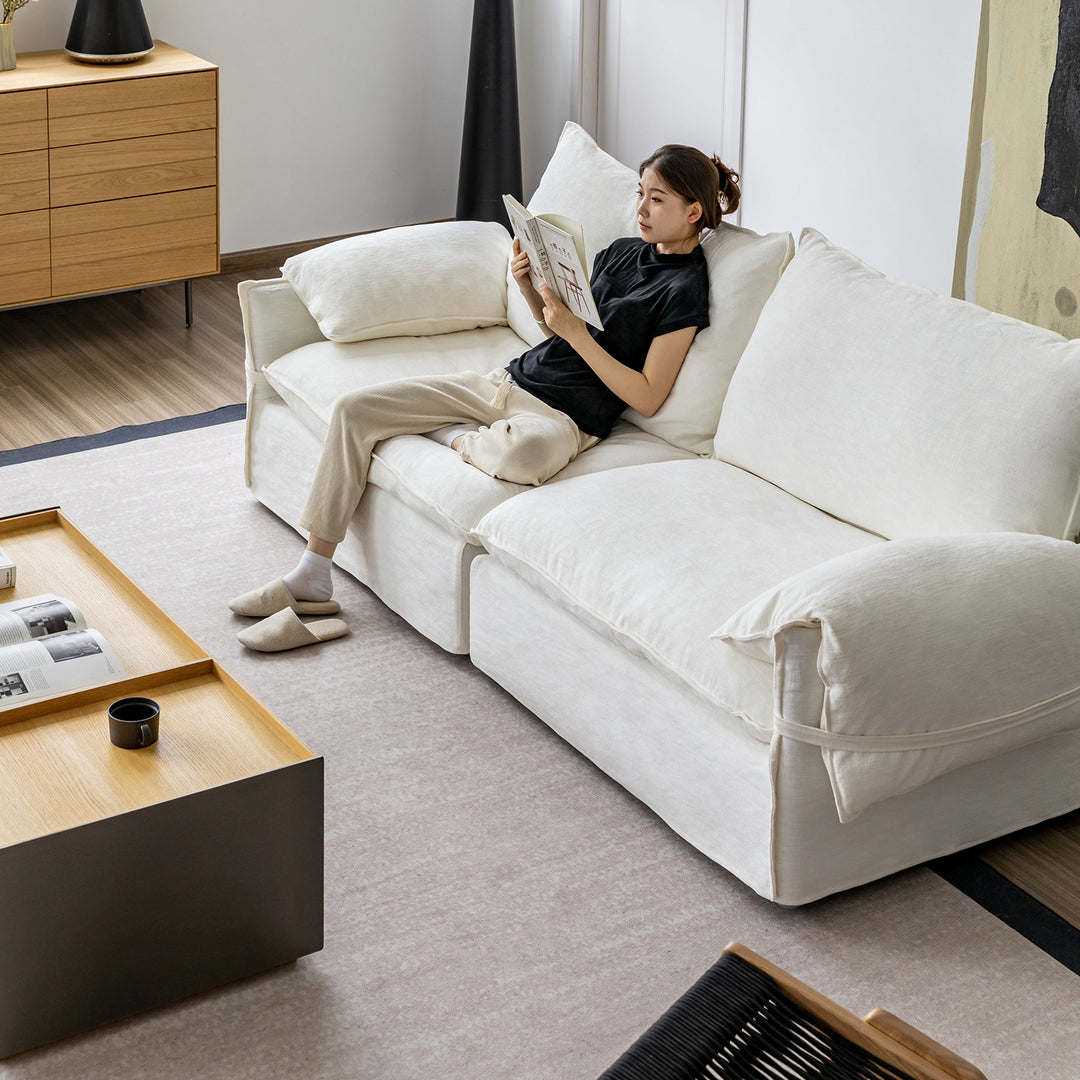 Cream cotton fabric 4 seater sofa folding ear in still life.