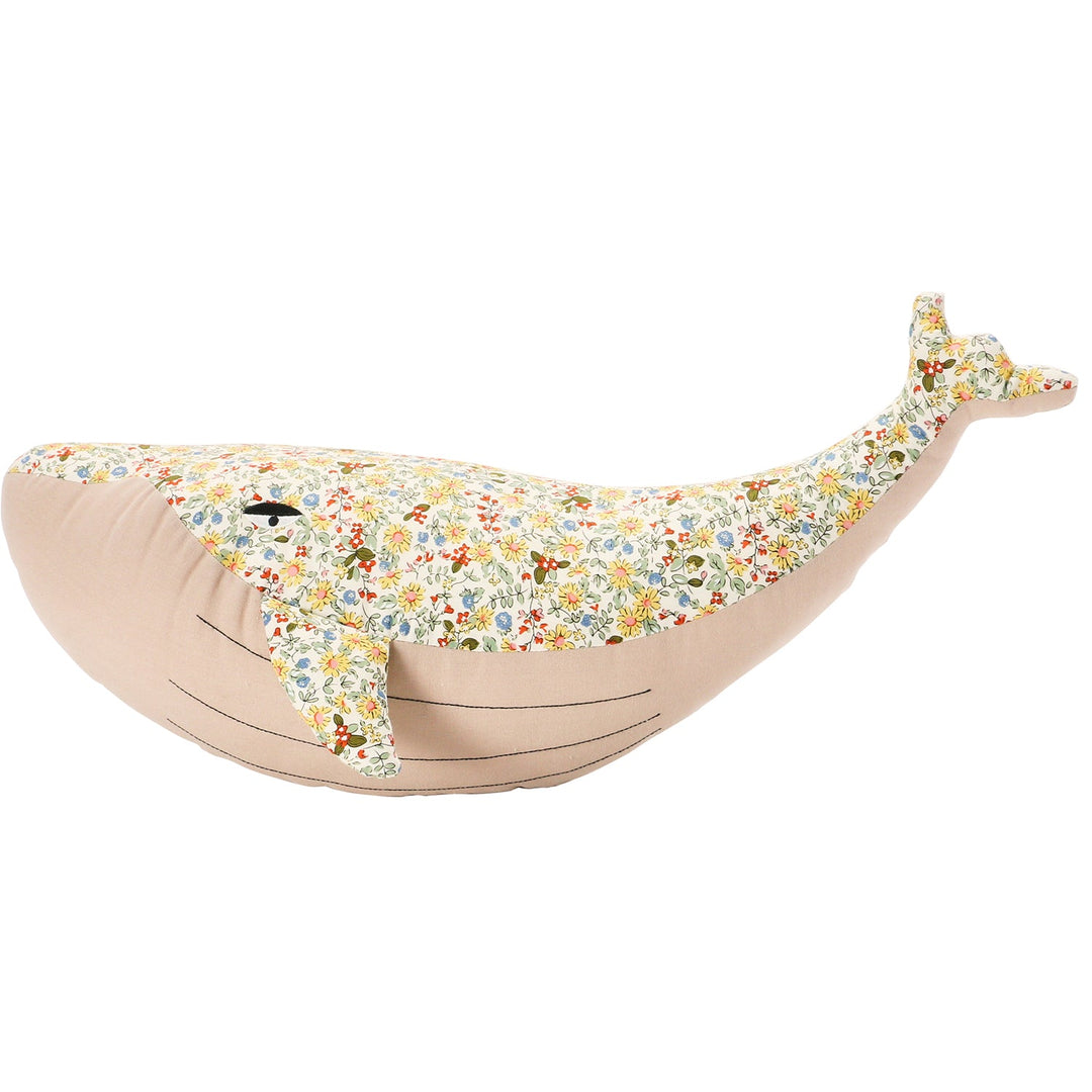 Detailed floral print plush whale bedroom decor with context.