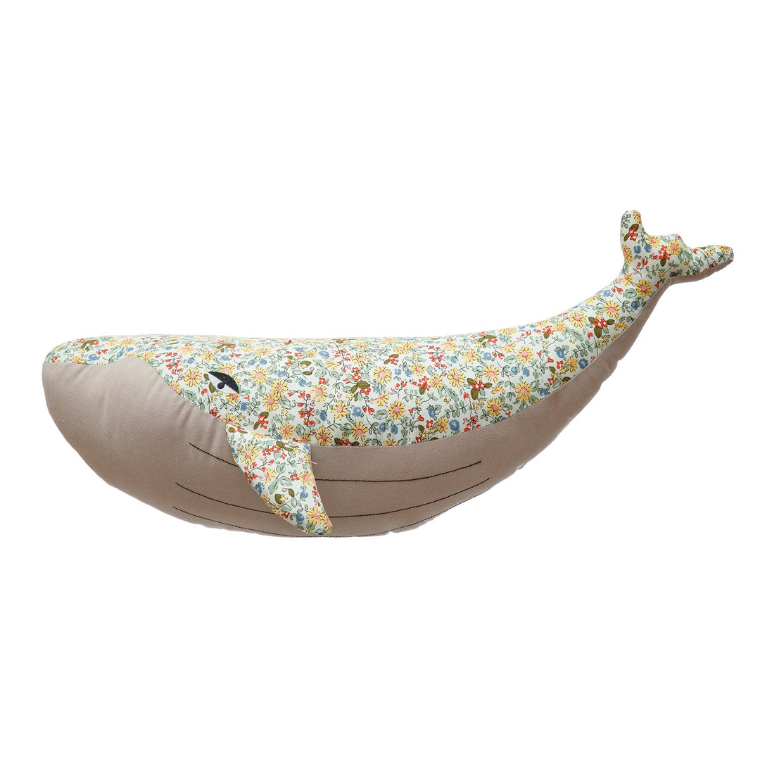 Detailed floral print plush whale bedroom decor in white background.