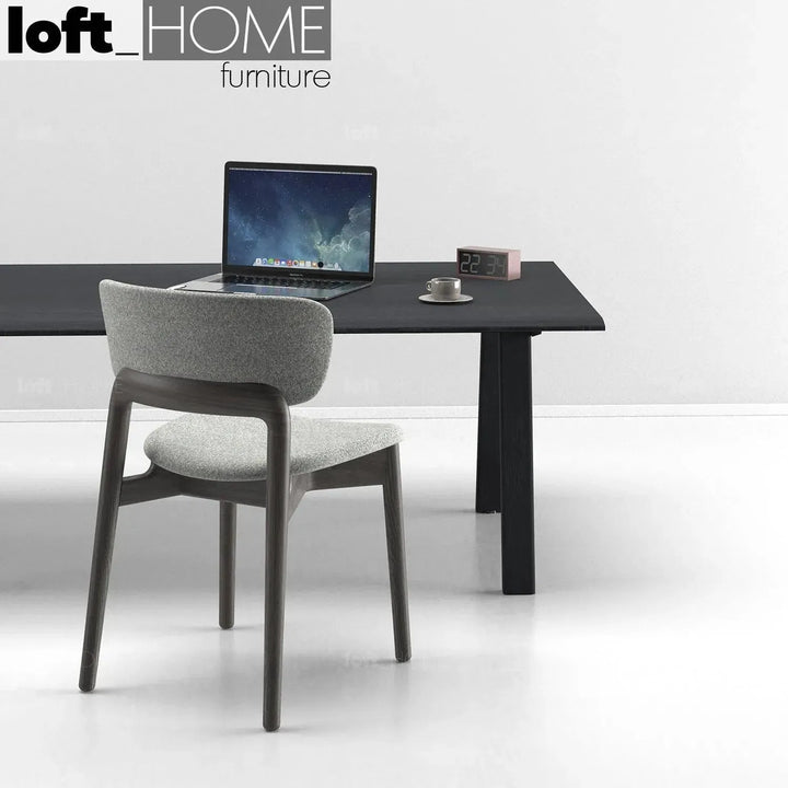 Minimalist fabric dining chair wood black in still life.