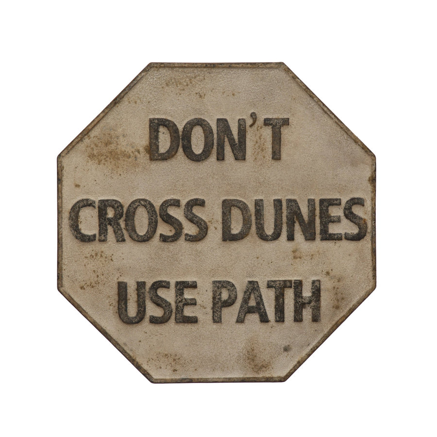 Embossed metal vintage reproduction wall decor "don't cross dunes use path" in white background.