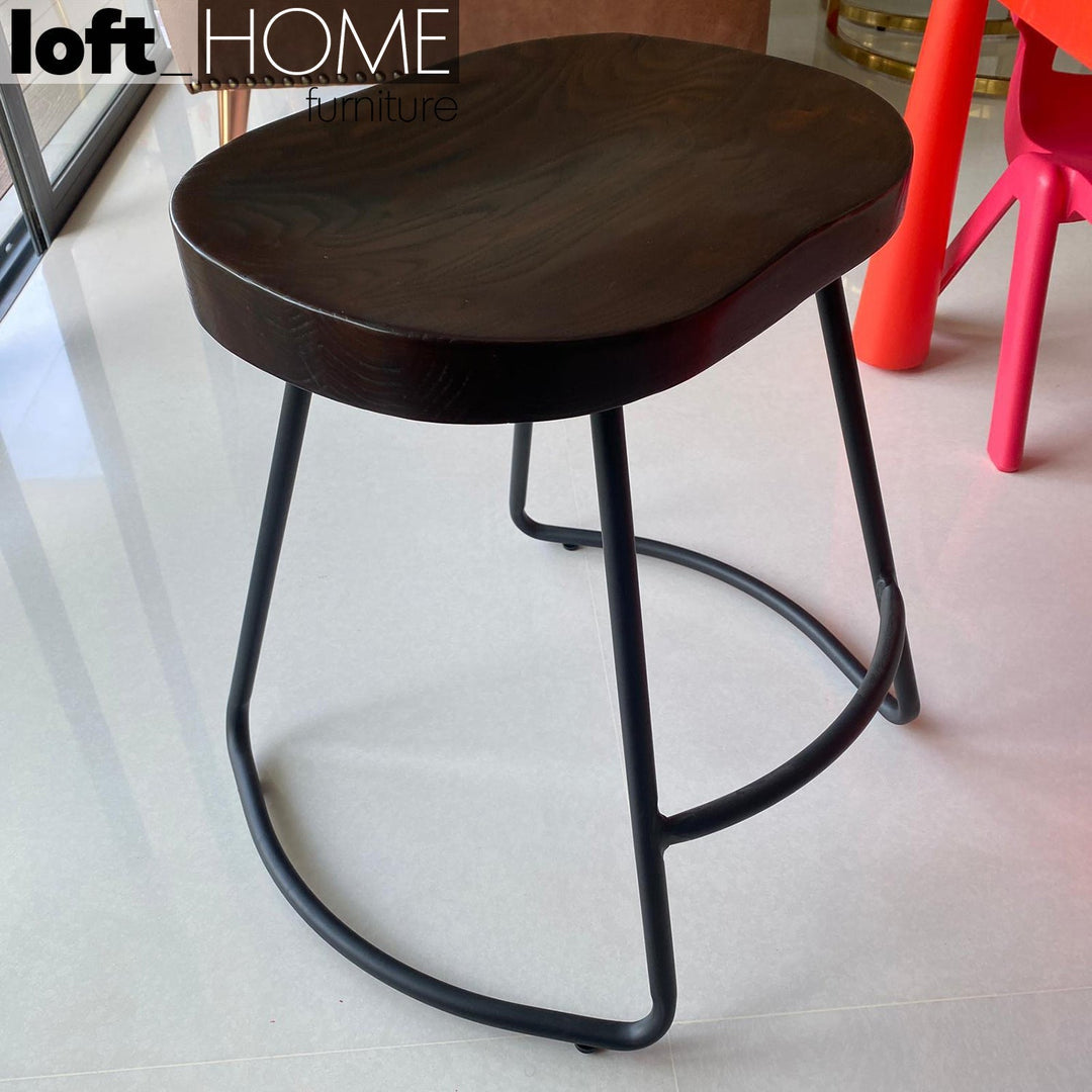 Industrial elm wood dining stool sanctum country in close up details.