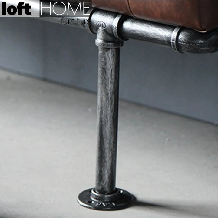 Industrial leather dining bench pipe in close up details.